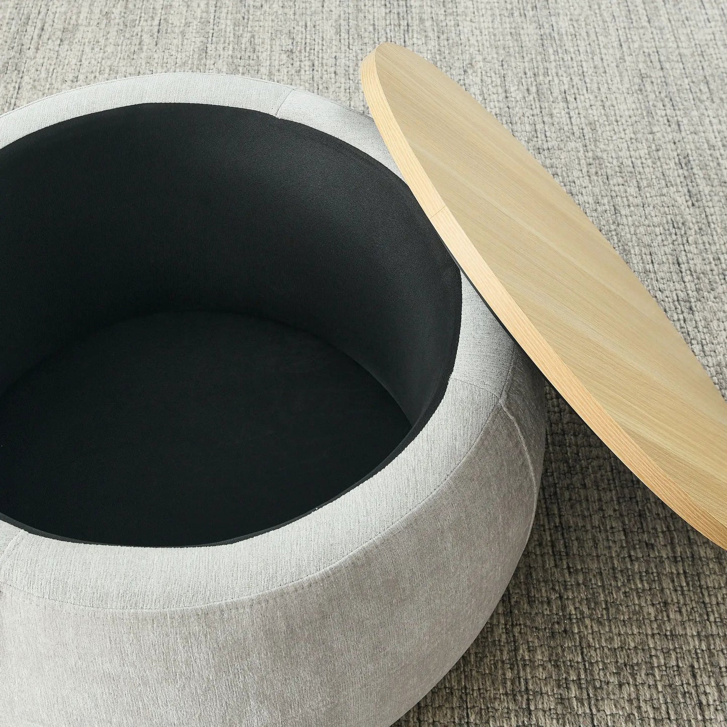Round storage ottoman with black cushioned top, gray fabric body, and natural wood edge on Tampa Home & Garden Store