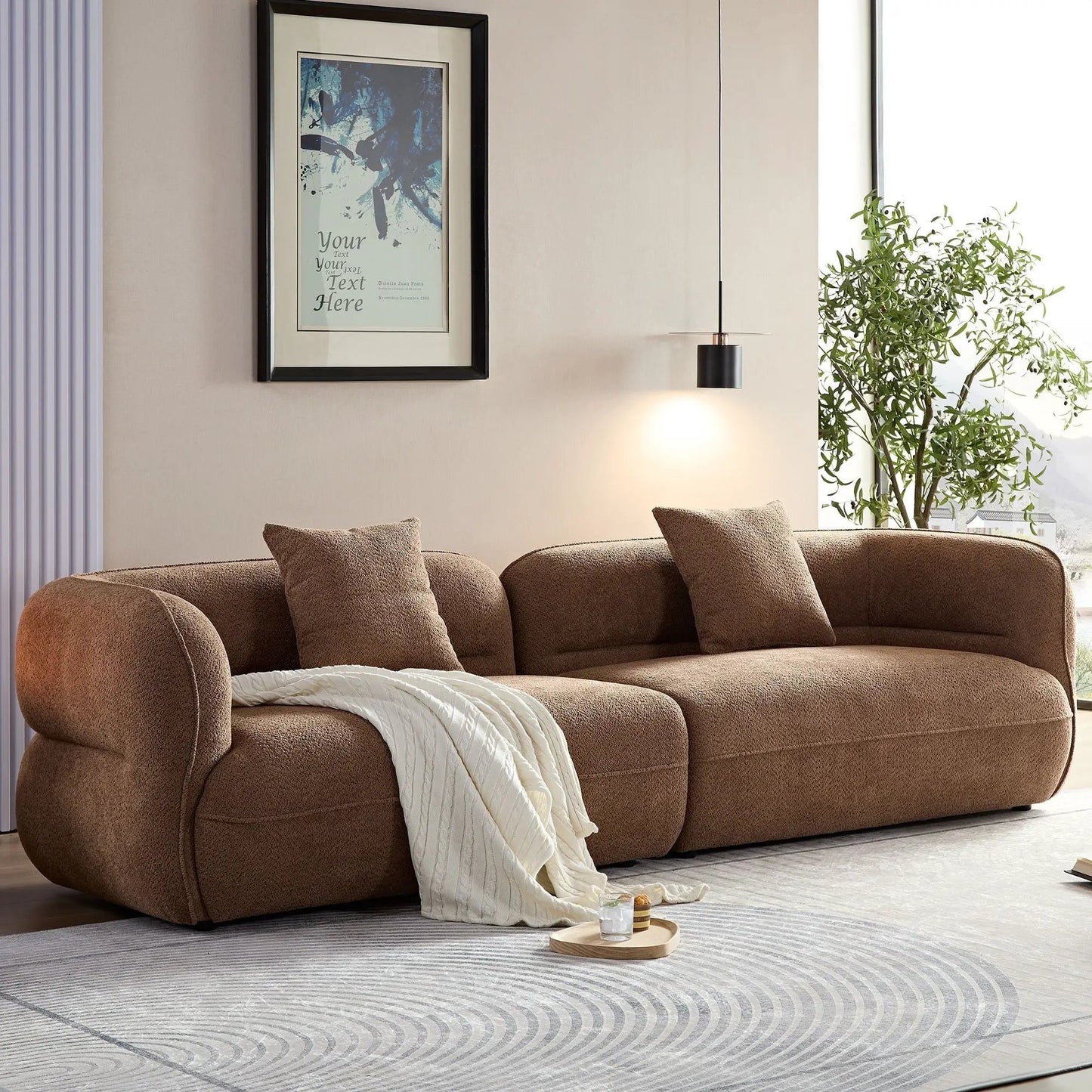 Sectional sofa in plush brown fabric with cushions and white throw on Tampa Home & Garden Store