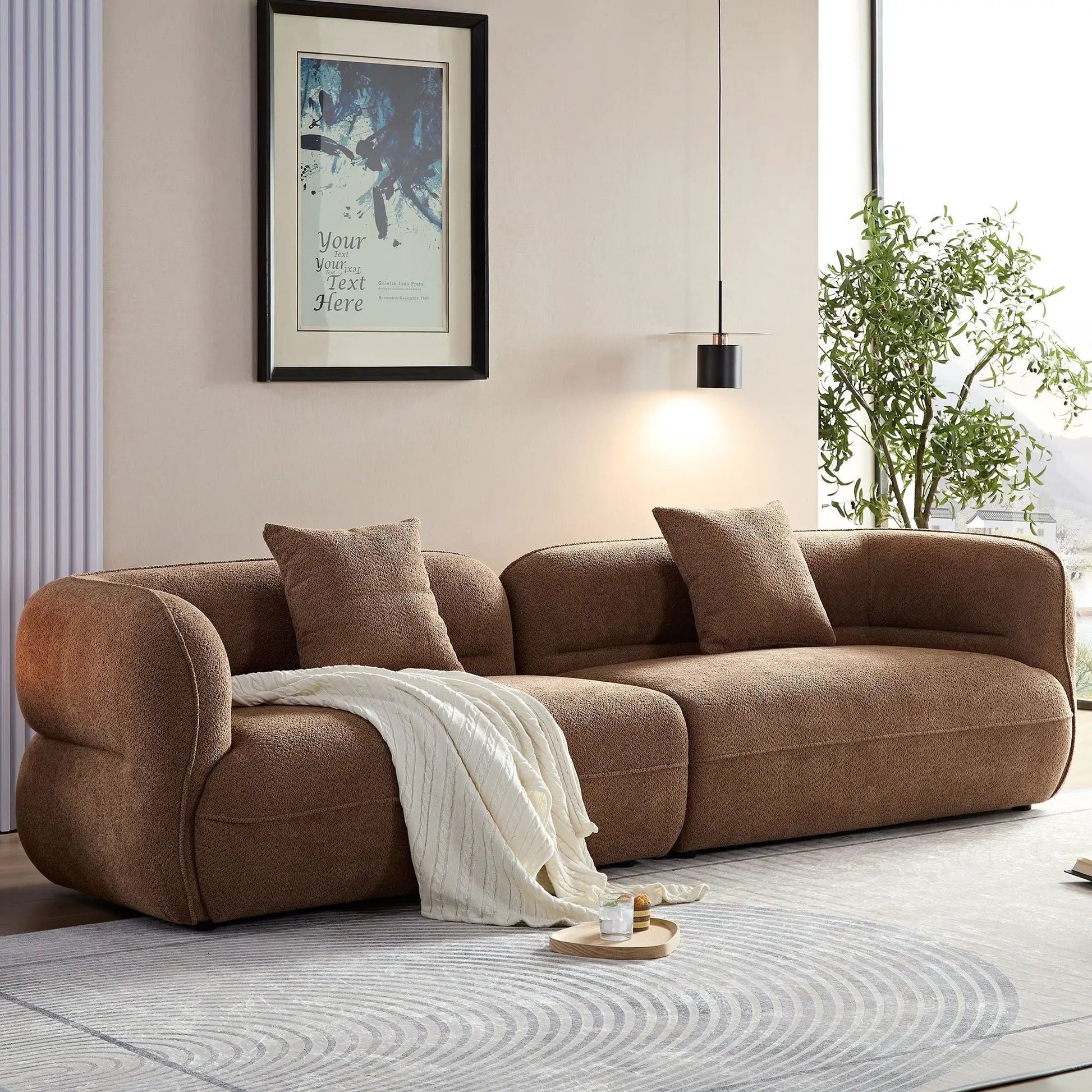 Sectional sofa in plush brown fabric with cushions and white throw on Tampa Home & Garden Store