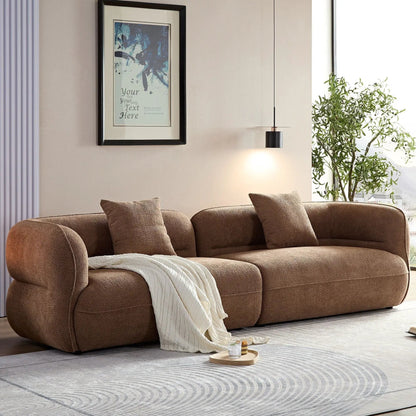 Sectional sofa in plush brown fabric with cushions and white throw on Tampa Home & Garden Store