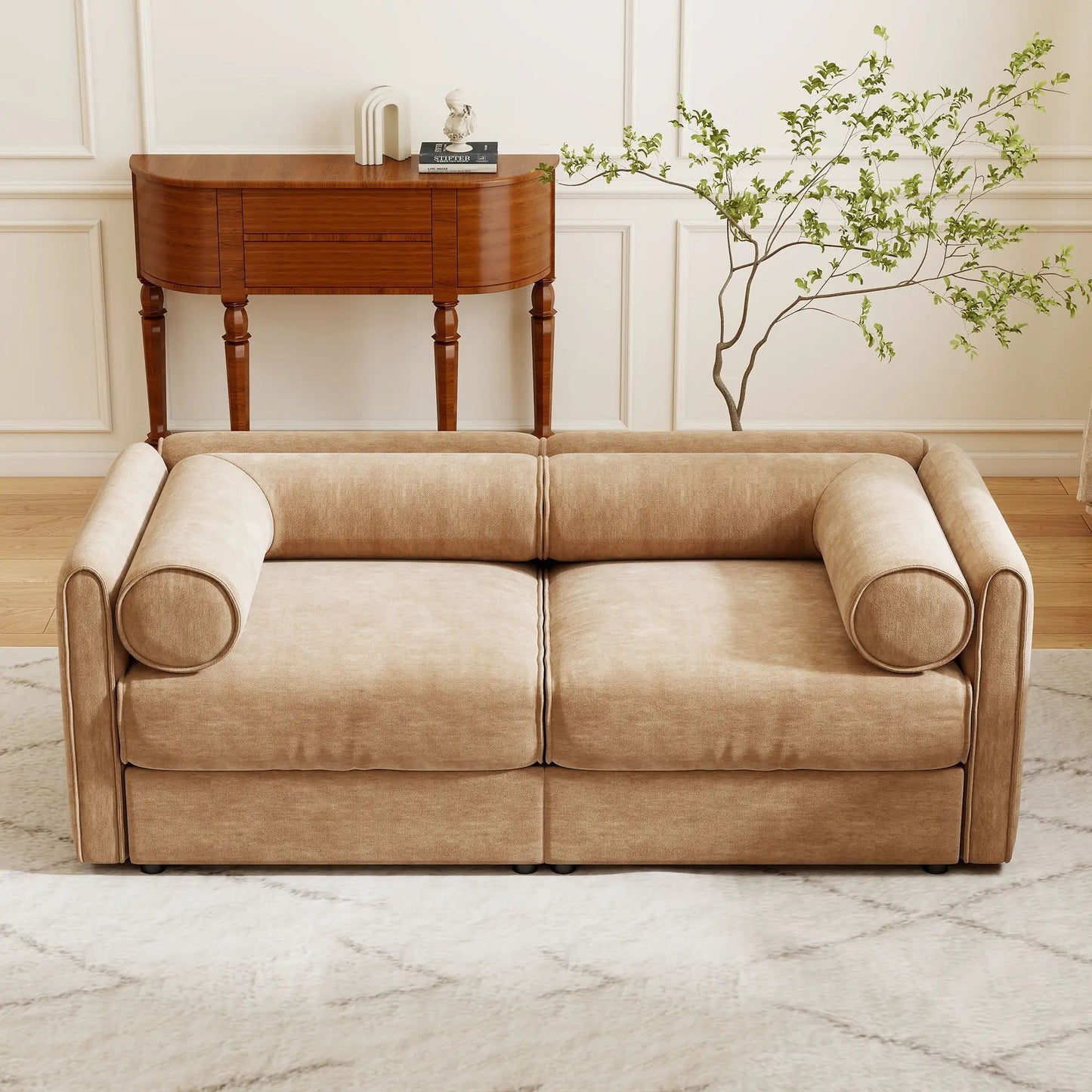 Beige stationary sofa with rolled arms beside a dark wood storage console and leafy plant on Tampa Home & Garden Store