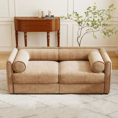 Beige stationary sofa with rolled arms beside a dark wood storage console and leafy plant on Tampa Home & Garden Store