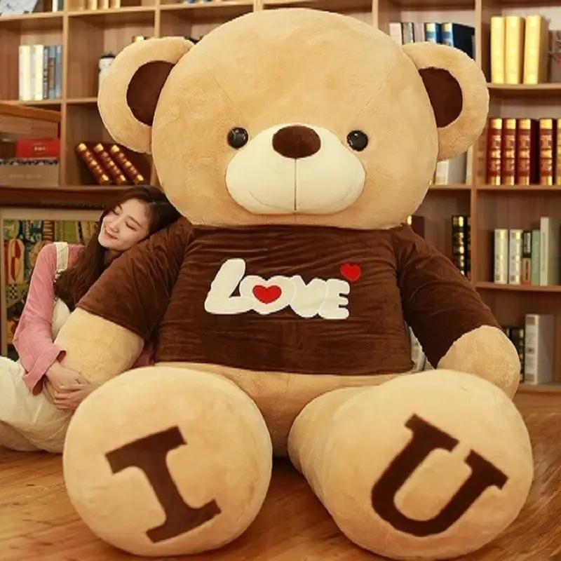 Heart bear plush toy in brown shirt with Love graphic, feet show T and U FLIPSTYLEZLLC on Tampa Home & Garden Store