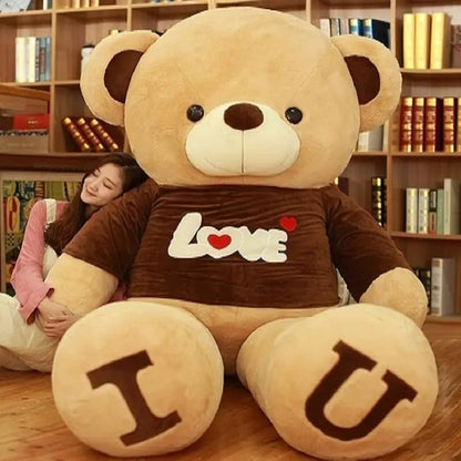 Heart bear plush toy in brown shirt with Love graphic, feet show T and U FLIPSTYLEZLLC on Tampa Home & Garden Store