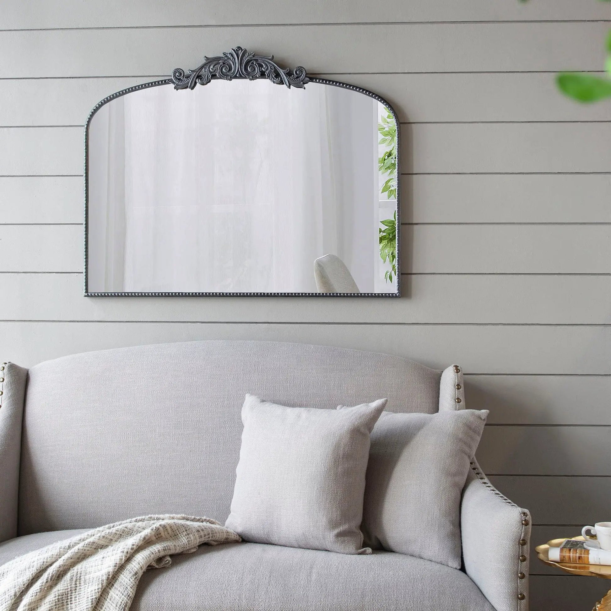 Arch mirror with ornate Baroque metal frame, silver finish and bead trim on gray wall on Tampa Home & Garden Store