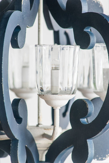 Cream wood farmhouse chandelier with dark blue iron scrollwork and clear glass shade on Tampa Home & Garden Store