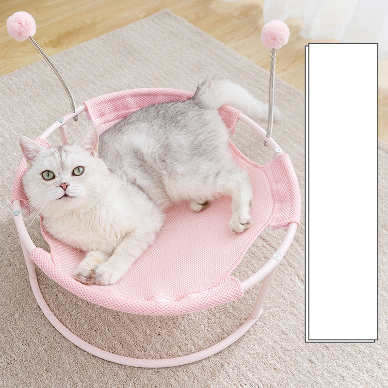 Pink round mesh cat bed hammock on white metal frame with pink pom-pom toppers, cat lounging on Tampa Home & Garden Store