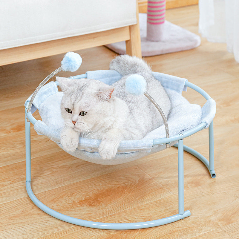 Cat hammock bed Sell My Stuff in light blue with plush mattress and pom pom accents on Tampa Home & Garden Store