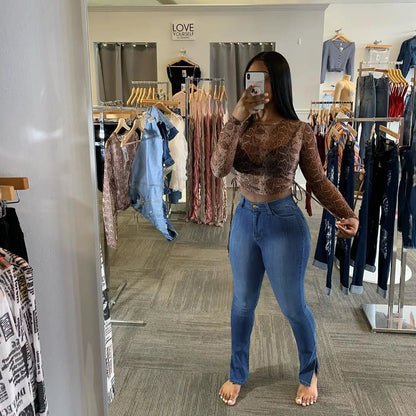 Jeans high-rise slim-fit split-leg pants in blue denim worn by a shopper posing in a store mirror on Tampa Home & Garden Store