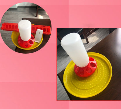 Bird feeder waterer with yellow dish, red hole ring, and white bottle on a wooden table on Tampa Home & Garden Store