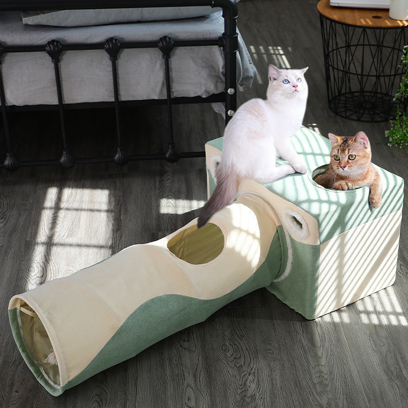 Cat tunnel house in cream and green fabric with two cats perched on top on Tampa Home & Garden Store