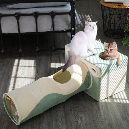 Cat tunnel house in cream and green fabric with two cats perched on top on Tampa Home & Garden Store
