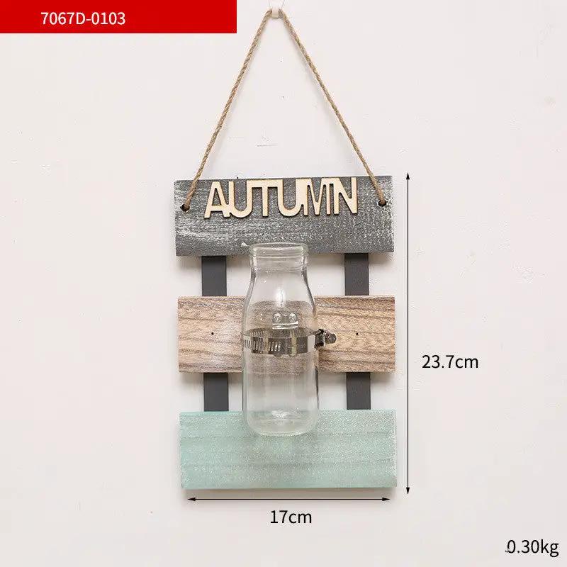 Glass bottle vase wall hanging on rustic pastel wood plaque with AUTUMN sign on Tampa Home & Garden Store