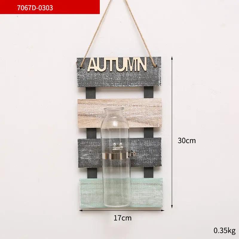 Plant glass vase on rustic wooden wall panel with Autumn sign pastel gray beige mint slats on Tampa Home & Garden Store