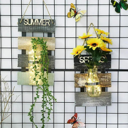 Glass plant vase wall hanging with rustic wood panels and string lights, greenery on Tampa Home & Garden Store