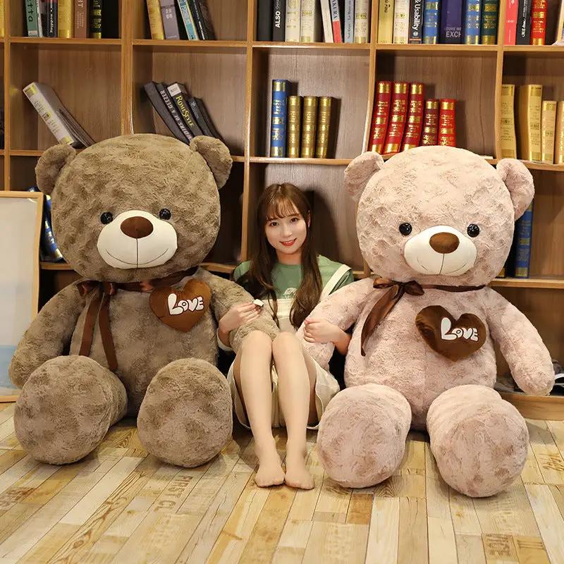 Large rose teddy bear hug plush: two oversized bears with LOVE heart tags beside a girl on Tampa Home & Garden Store