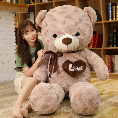 Large rose teddy bear plush with brown ribbon bow and heart patch reading LOVE by FLIPSTYLEZLLC on Tampa Home & Garden Store