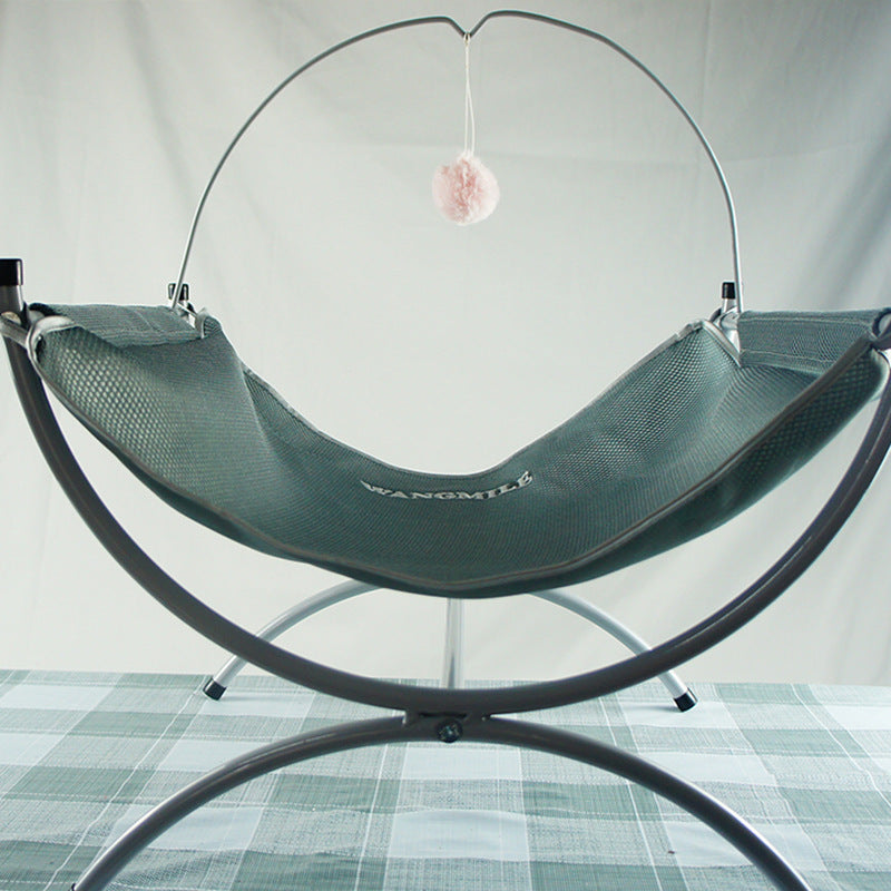 Four Seasons Universal Cat Recliner in green mesh hammock on metal stand with pink pom-pom on Tampa Home & Garden Store