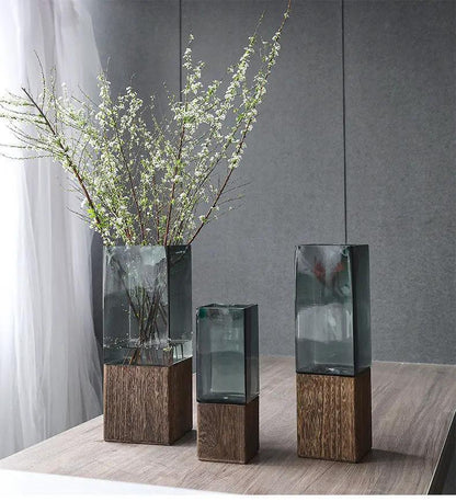 Wood color transparent glass vase set on wooden bases; three vases, left with branches on Tampa Home & Garden Store