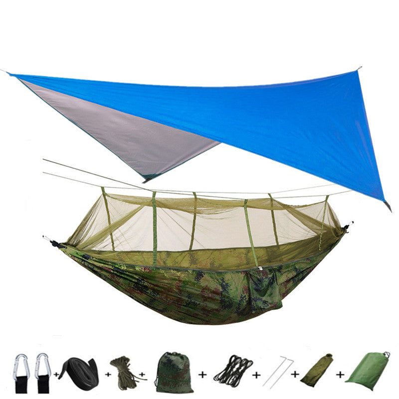 Outdoor double parachute hammock with mosquito net in army green camouflage under a blue tarp on Tampa Home & Garden Store