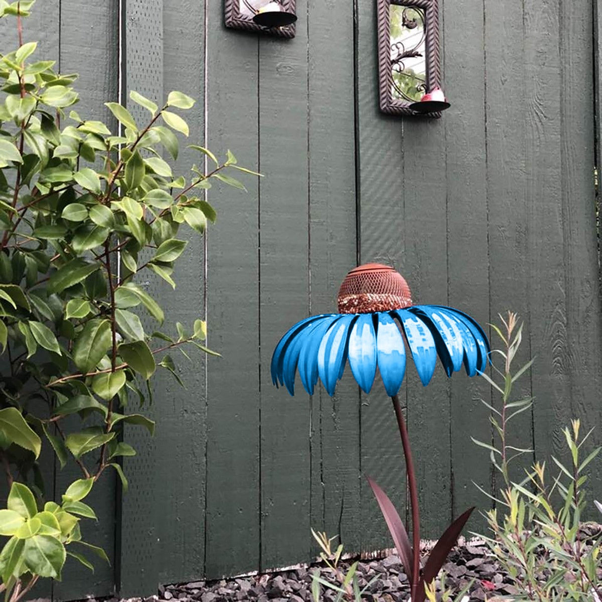 Garden Petal Shape Bird Feeder on a garden stake with bright blue petals near green fence on Tampa Home & Garden Store