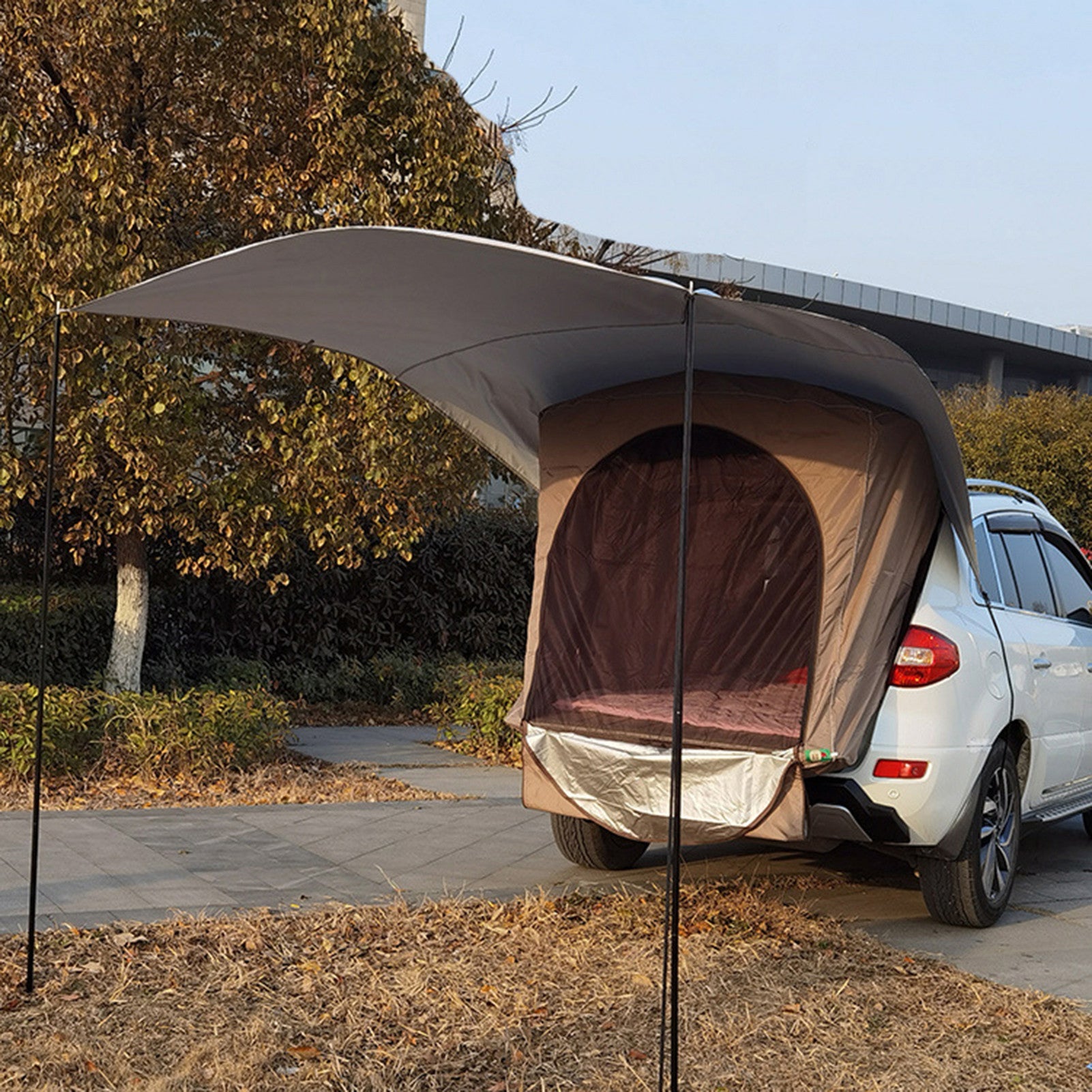 Car tail canopy camping tent attached to SUV trunk with beige fabric and curved shade on Tampa Home & Garden Store