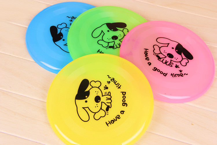 Four silicone flying saucer dog toys in blue, green, pink, yellow with cartoon dogs for interactive play on Tampa Home & Garden Store