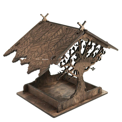 Wooden bird feeder with carved leaf-pattern roof and tree-branch side panels, rustic finish on Tampa Home & Garden Store