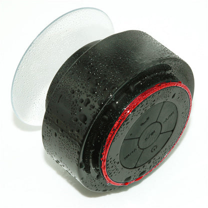 Waterproof Bluetooth speaker round black portable unit with red ring and clear suction cup on Tampa Home & Garden Store