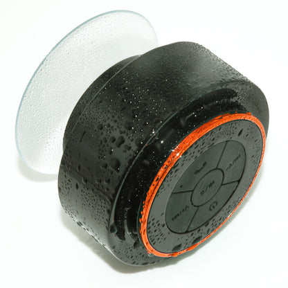 Waterproof Bluetooth portable speaker, black with orange ring and white suction cup on Tampa Home & Garden Store
