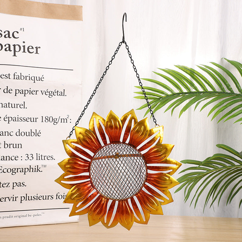 Wrought iron flower-shaped bird feeder with orange-gold petals and mesh center, hanging chain on Tampa Home Garden Store