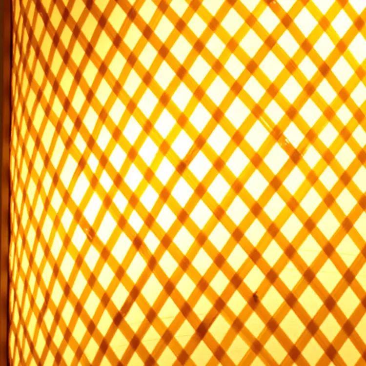 Wall lamp bamboo lattice shade with warm glow and wood frame on Tampa Home & Garden Store