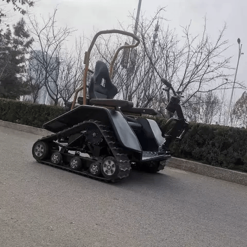 Allterain electric wheelchair with black tracked chassis and high-back seat on a paved road on Tampa Home & Garden Store
