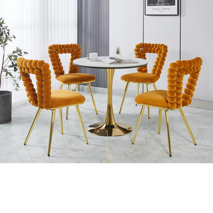 Modern chair set orange velvet cushions and gold iron-tube legs around a white marble table on Tampa Home & Garden Store