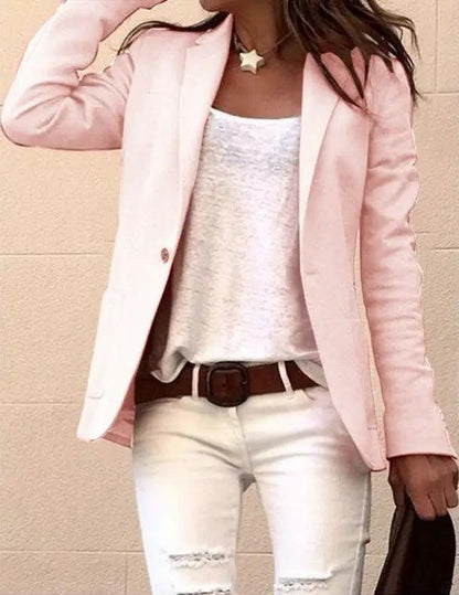 Candy-colored long-sleeved pink blazer with white top and white jeans, brown belt on Tampa Home & Garden Store
