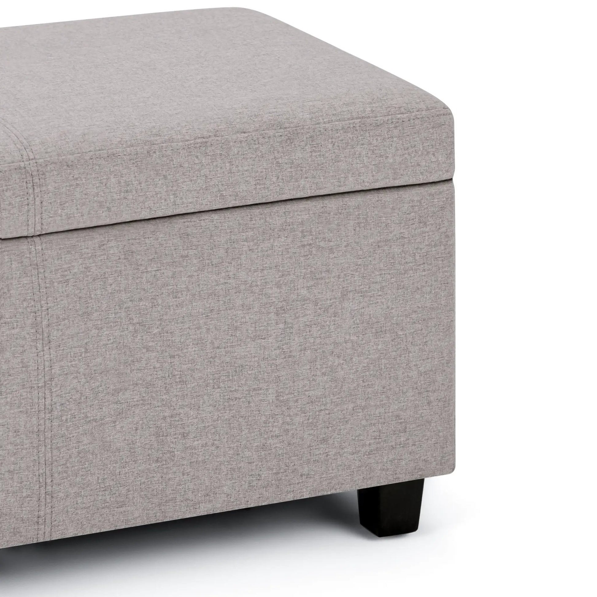 Avalon storage ottoman bench in light gray textured fabric with black wooden legs on Tampa Home & Garden Store