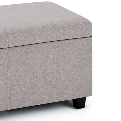 Avalon storage ottoman bench in light gray textured fabric with black wooden legs on Tampa Home & Garden Store