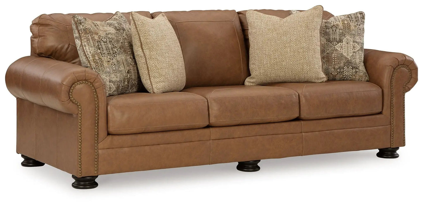 Carianna sofa in caramel leather with rolled arms, nailhead trim, and decorative throw pillows on Tampa Home & Garden Store