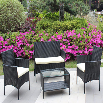 4 pc rattan patio set with black wicker chairs and cushions around table amid azalea blooms on Tampa Home & Garden Store