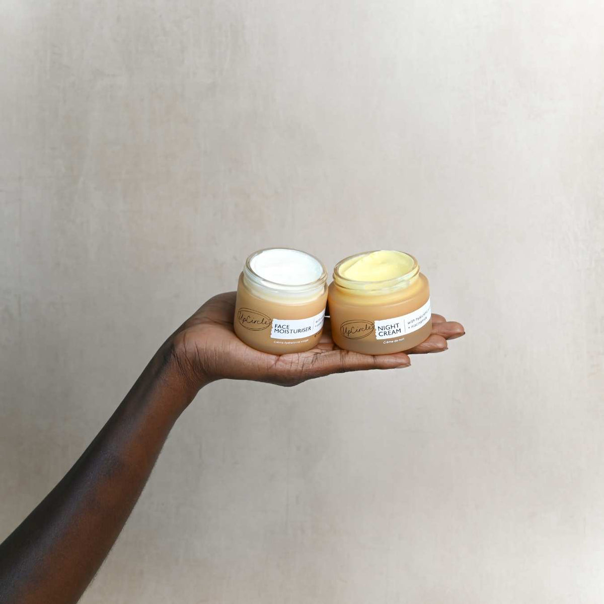 Day + Night Hydration Set by UpCircle with two jars face moisturiser and night cream held in hand on Tampa Home & Garden Store