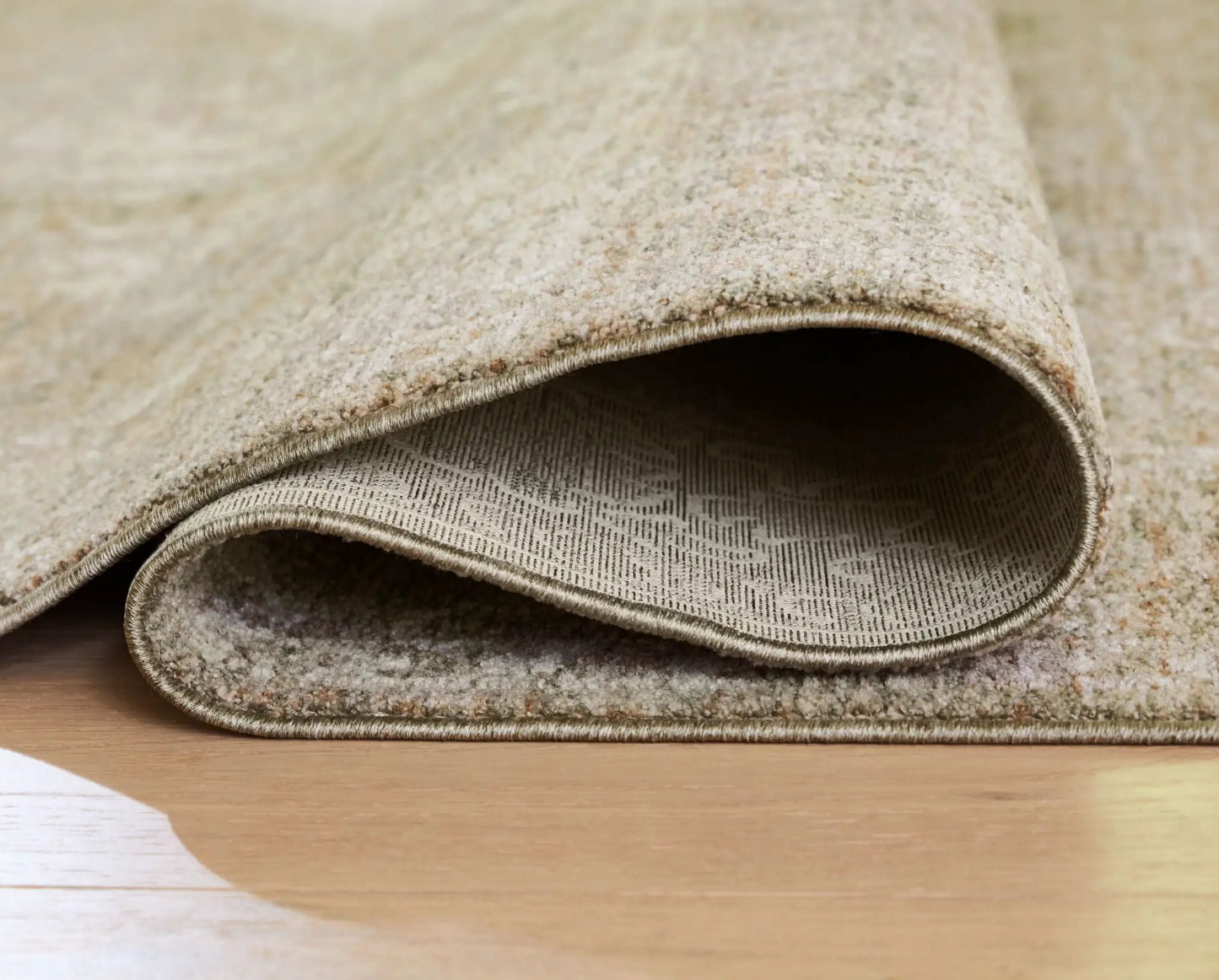 Neroham rug by Unique Piece Furniture beige neutral textured area rug rolled edge view on Tampa Home & Garden Store