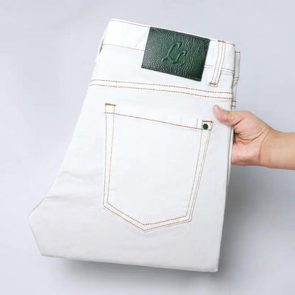 Men's white washed denim jeans with brown topstitching and green leather patch on Tampa Home & Garden Store