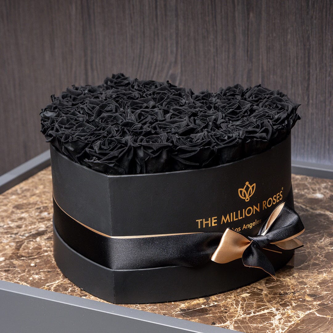 Heart-shaped black box of black roses from The Million Roses, gold ribbon bow on Tampa Home & Garden Store