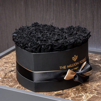 Heart-shaped black box of black roses from The Million Roses, gold ribbon bow on Tampa Home & Garden Store