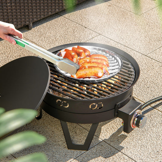 GemGear 17-inch black gas fire pit with folding legs and removable grill grilling sausages on Tampa Home & Garden Store