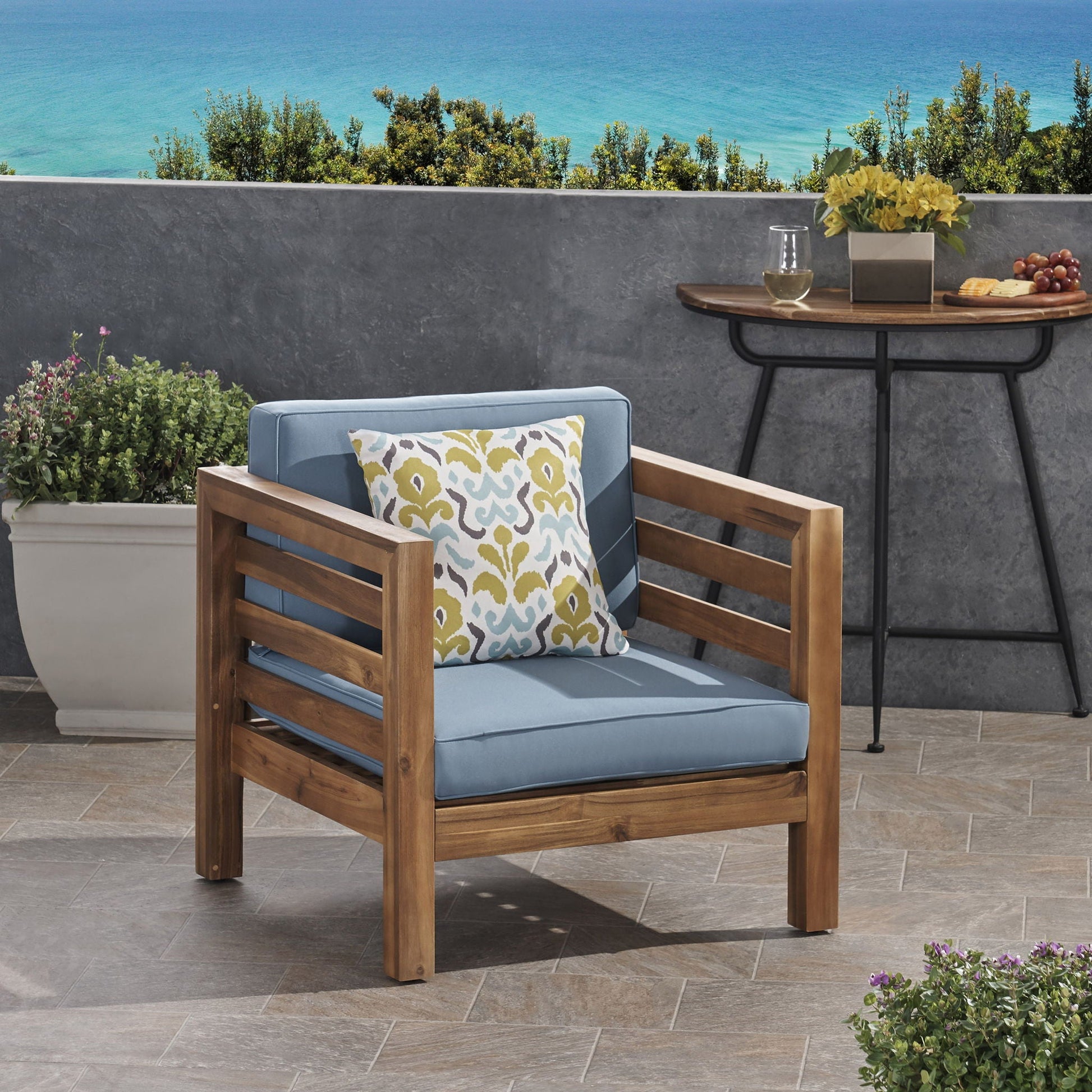 Outdoor acacia wood arm chair with blue fabric cushion and decorative pillow by HouseOfZazla on Tampa Home & Garden Store