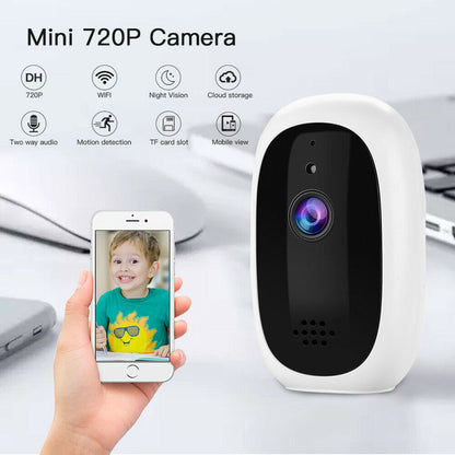 Mini 720P security camera with white body and black front, lens visible beside a smartphone on Tampa Home & Garden Store
