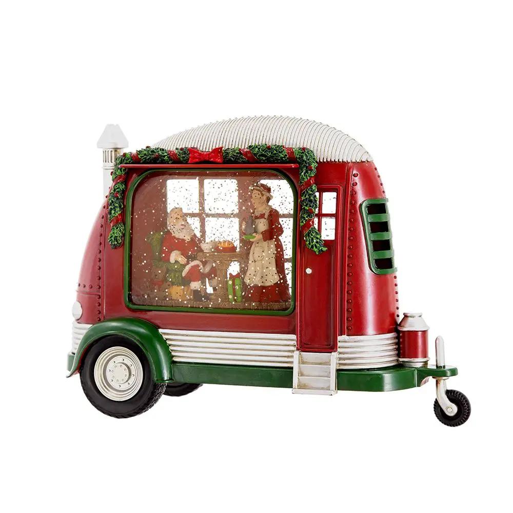 Red plastic resin Christmas camper with Mr & Mrs Santa tea-time scene inside, garland trim on Tampa Home & Garden Store