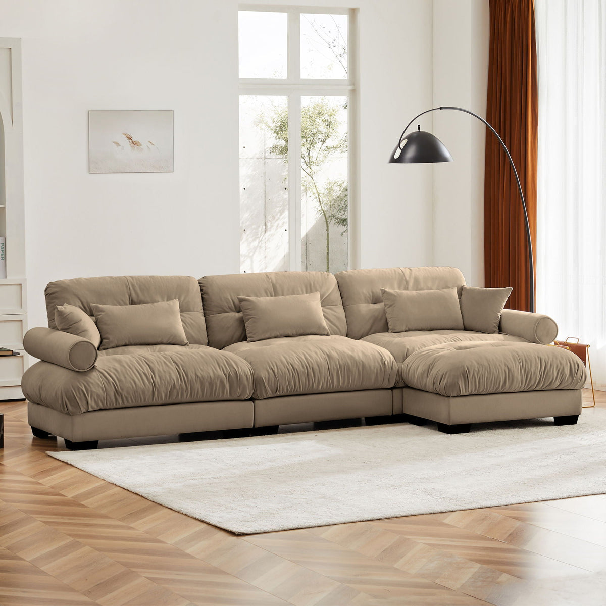 Beige modern 2-piece sectional sofa with ottoman featuring round bolster arms and plush cushions on Tampa Home & Garden Store