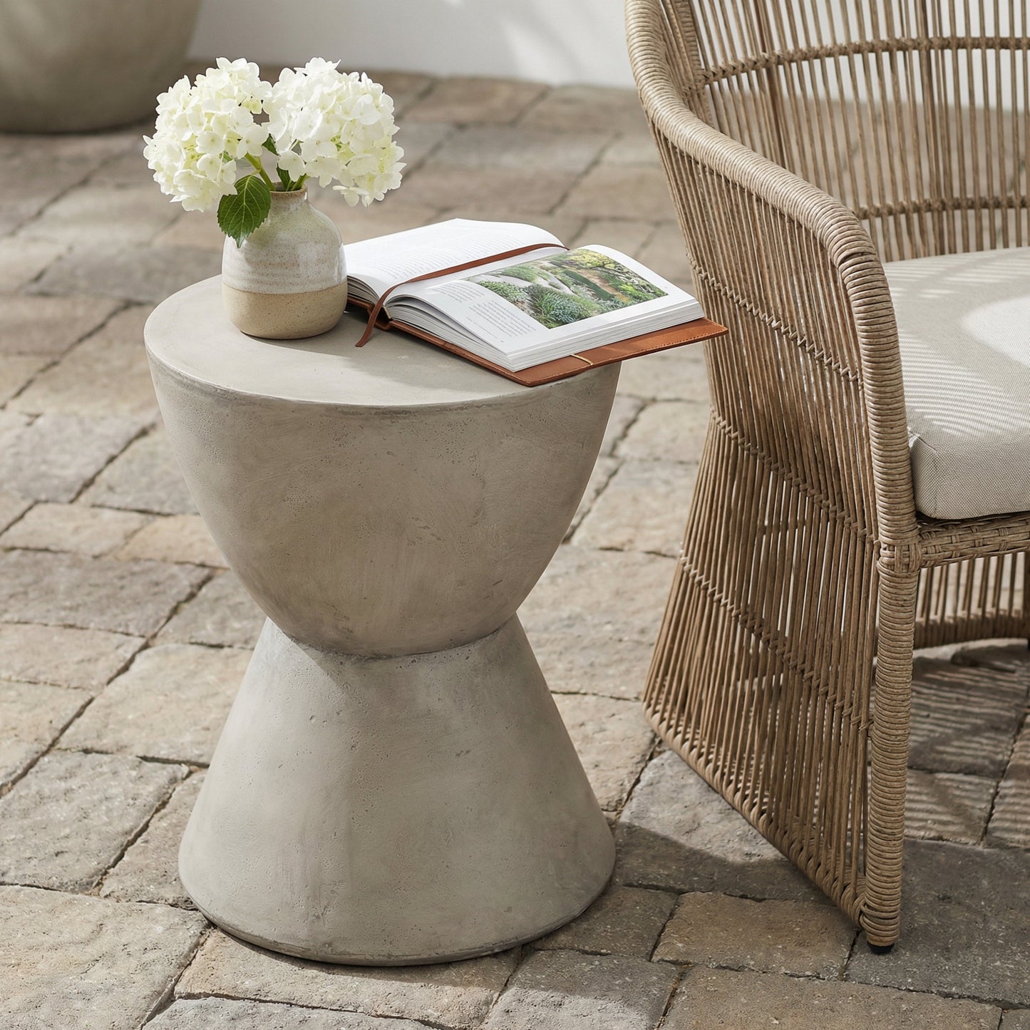 Outdoor Concrete Side Table light gray with white hydrangea vase and open book HouseOfZazla on Tampa Home & Garden Store